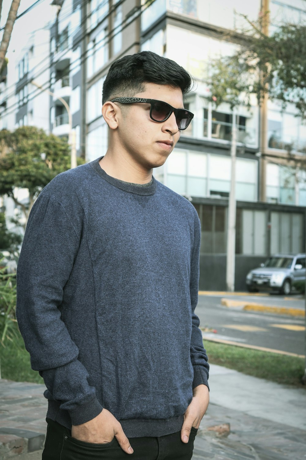 man standing near high-rise building