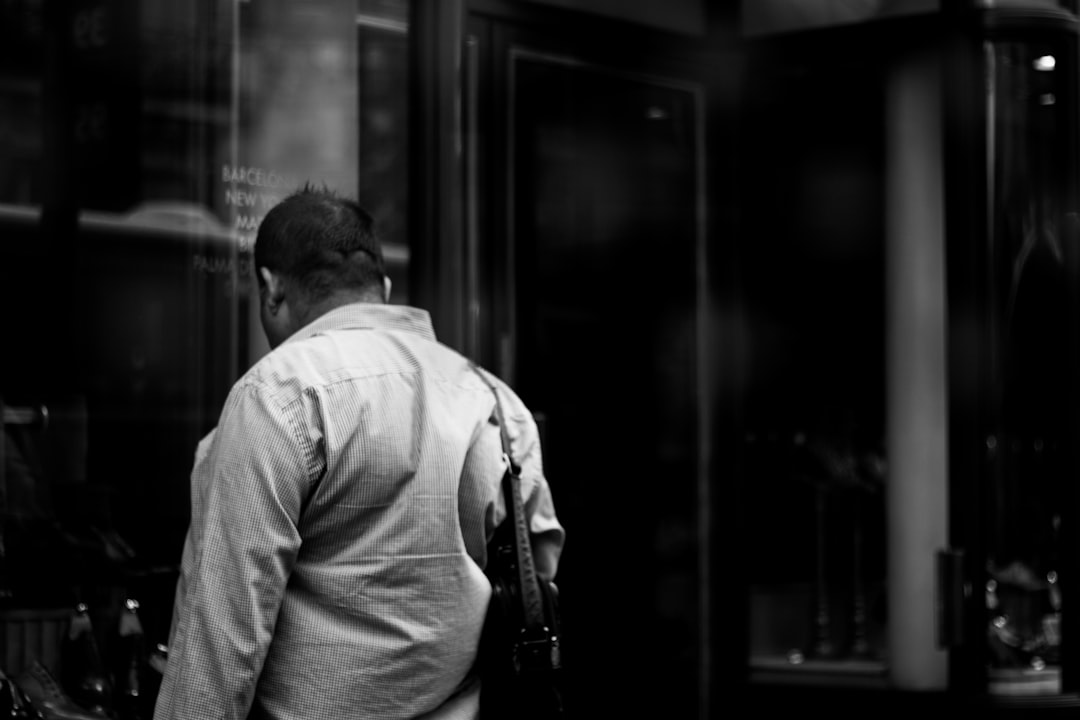 man in dress shirt with leather handbag