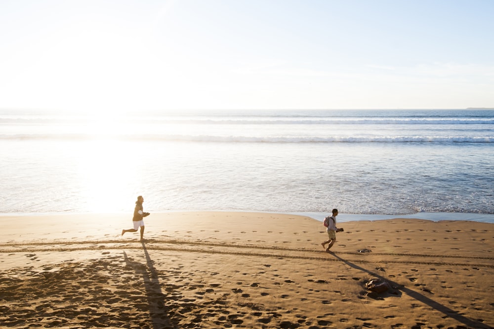 man chasing child in beach