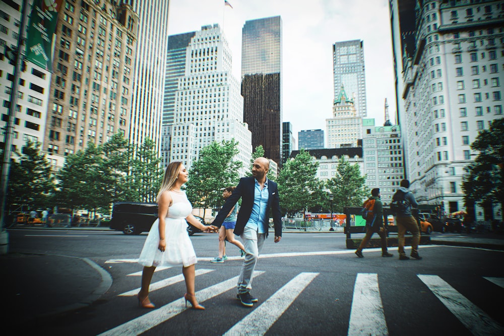 man and woman crossing street hand in hand