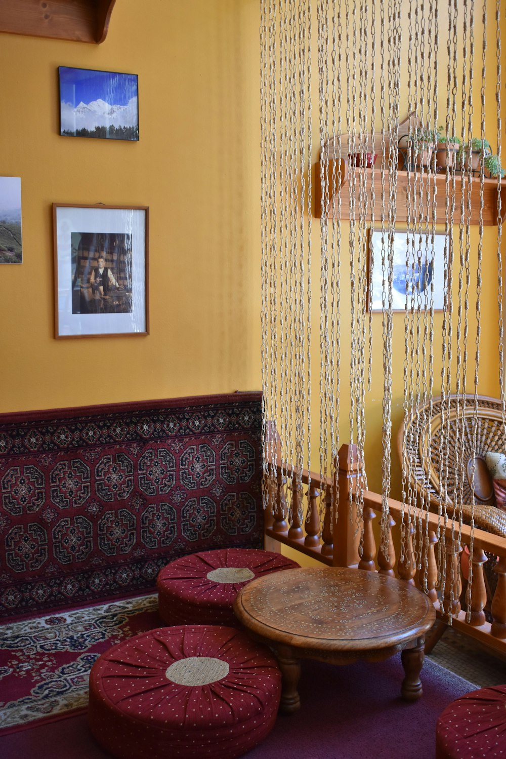 a living room with a hammock and ottomans