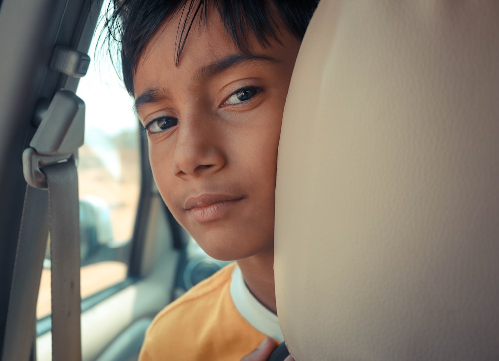 boy inside vehicle during daytime