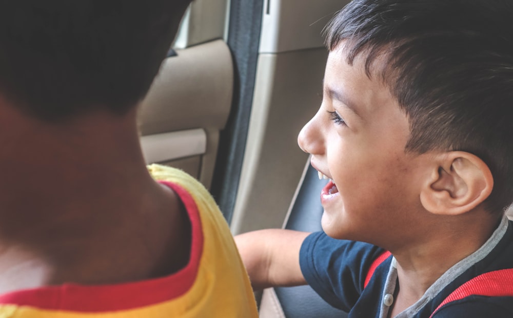 boy sitting inside vehicle