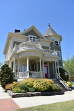 white and gray wooden 2-storey house