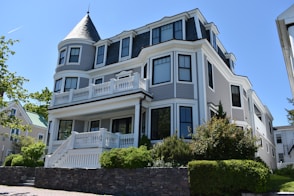 white and blue 3-storey house