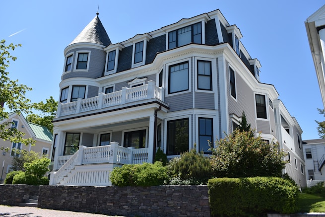 white and blue 3-storey house