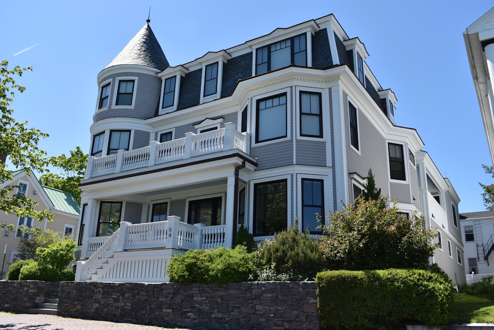 white and blue 3-storey house