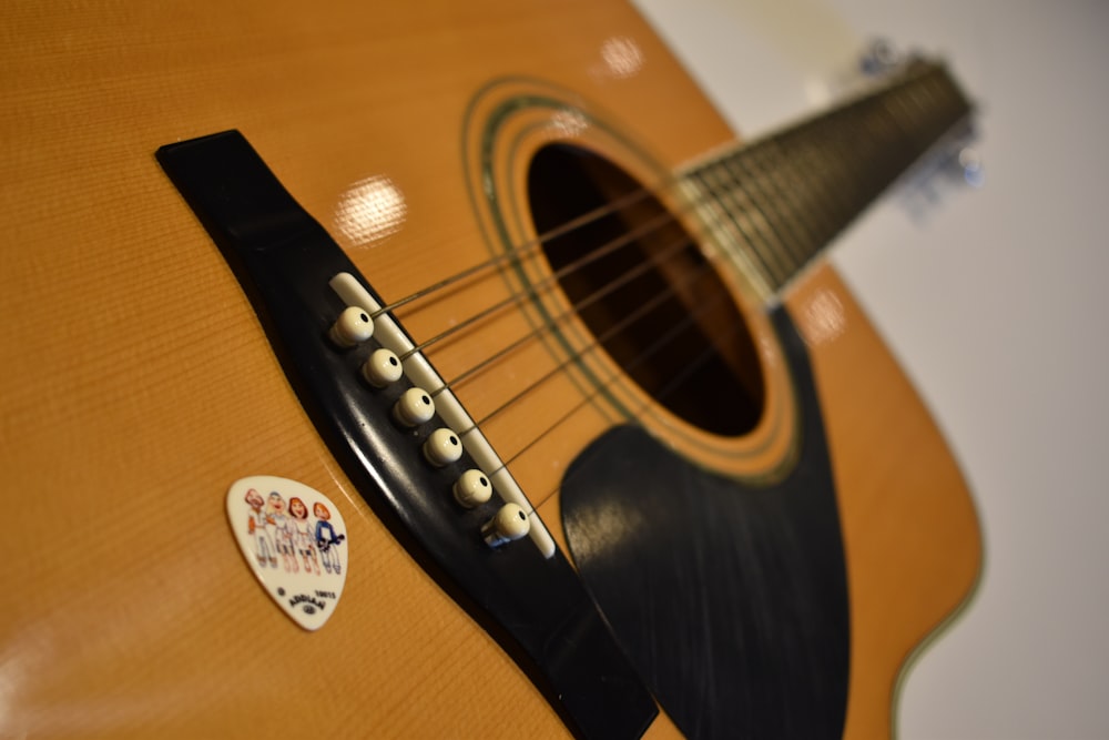 a close up of a guitar with a sticker on it