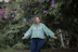 Smiling woman standing in front of green lots at El Llano development.