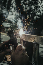 Close-up of welding sparks flying as a worker repairs a ship hull.