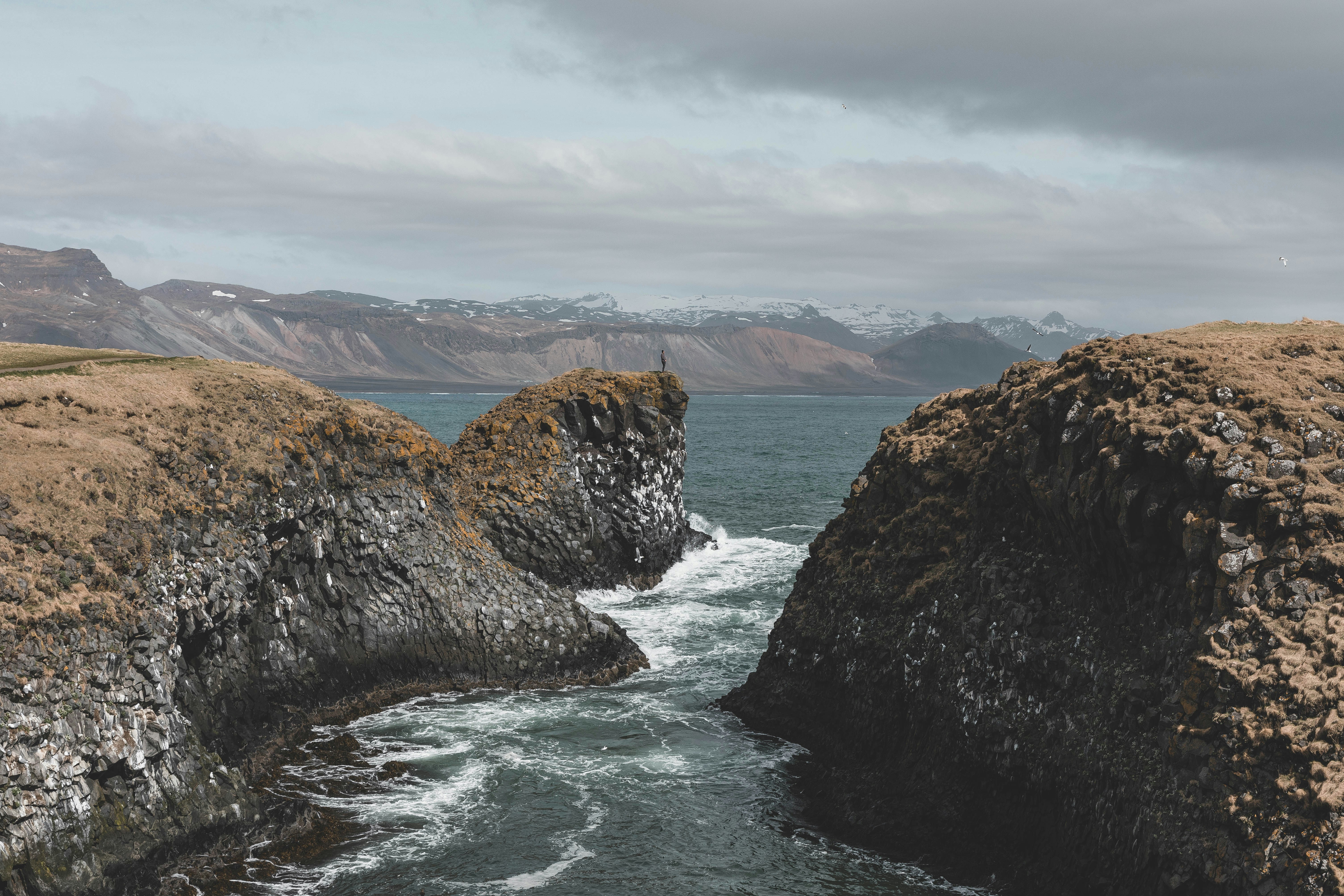 architectural photography of brown rock formation epic teams background