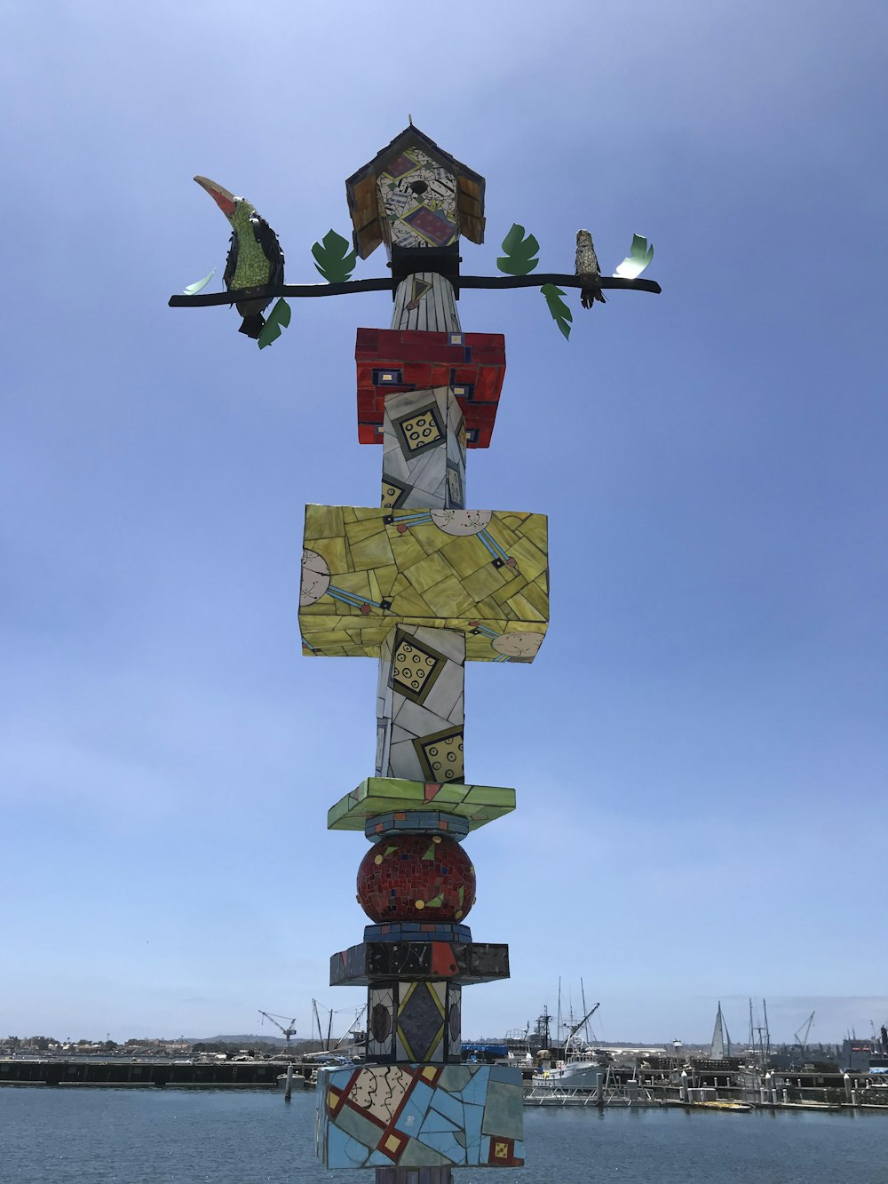 multicolored wooden birdhouse under blue sky