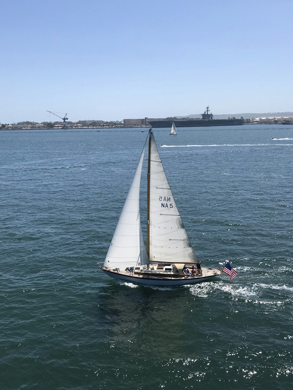 white and blue sail boat on body of water