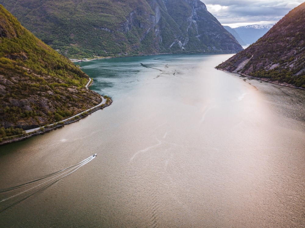 landscape photo of body of water and green mountains