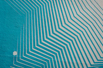 A striking geometric pattern mural on a modern home interior wall.