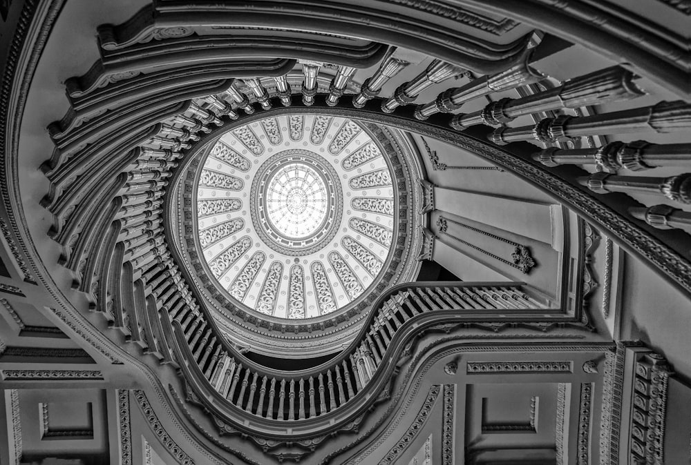 a spiral staircase in a building with a circular window