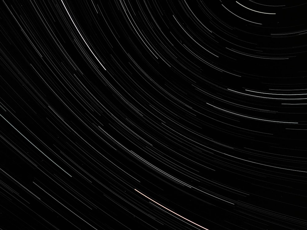a black and white photo of a star trail