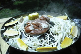 A steaming skillet with colorful vegetables sizzling over high heat