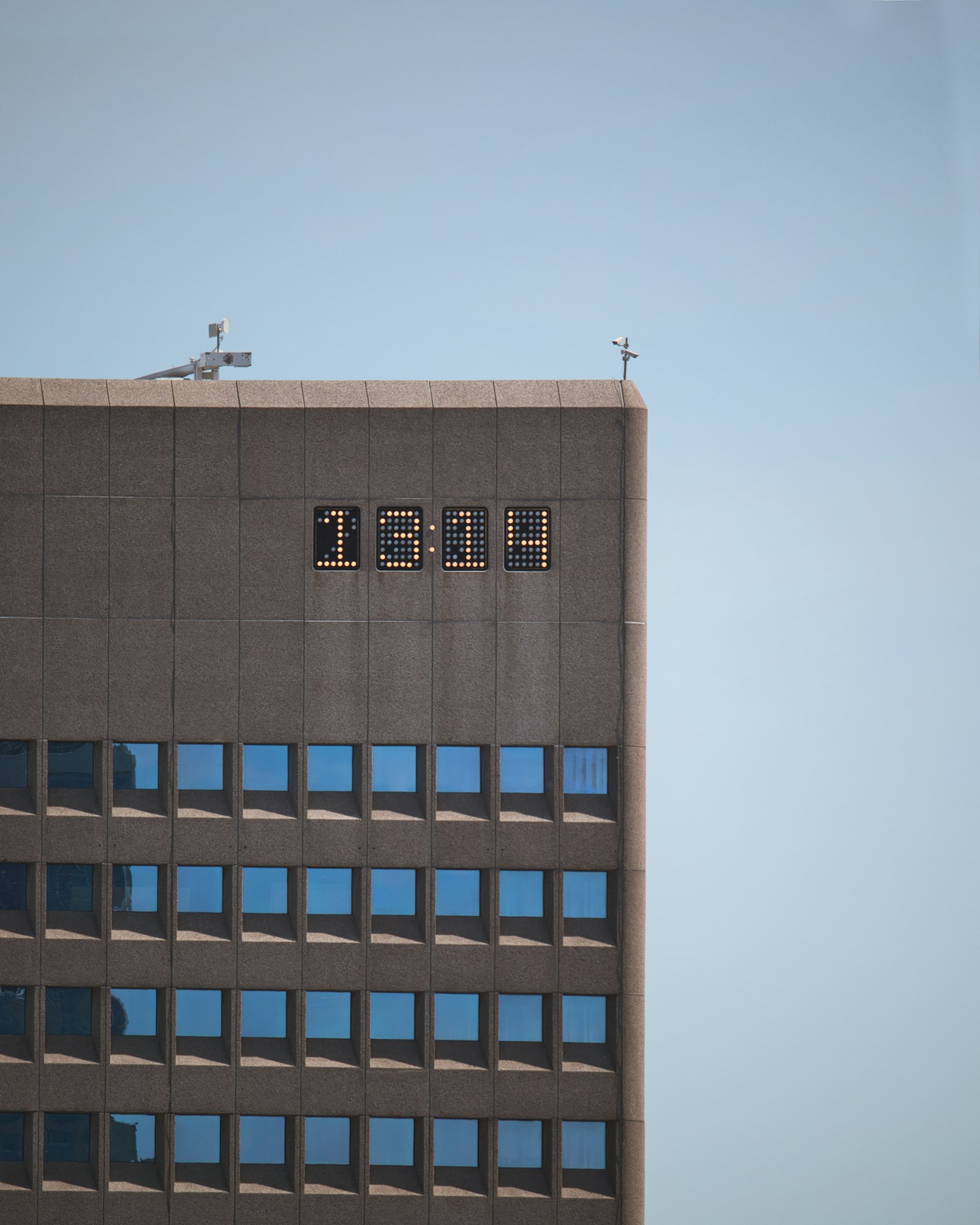 Canon EF-S 55-250mm F4-5.6 IS STM sample photo. Gray building showing 13:14 photography