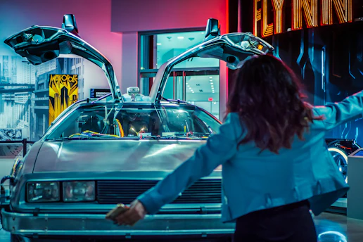 woman standing in front of white vehicle