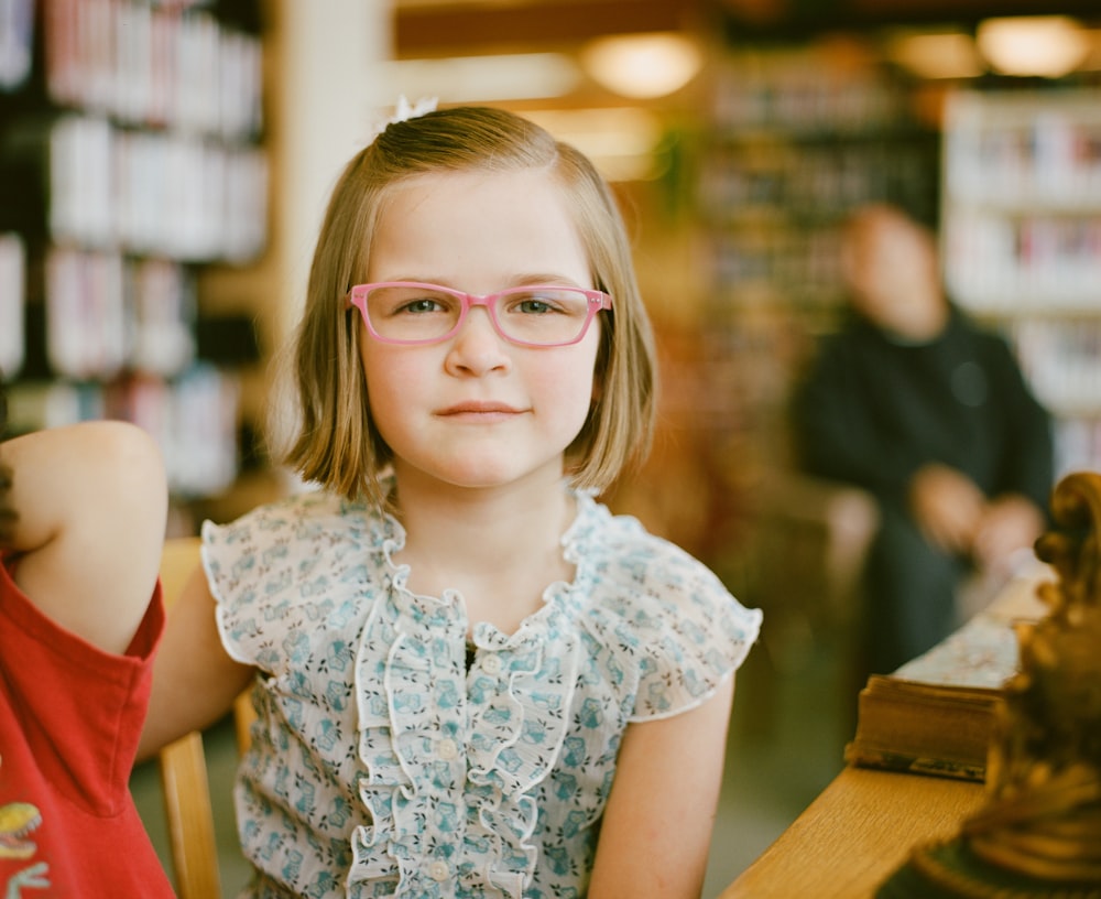 selective focus of girl sitting at table