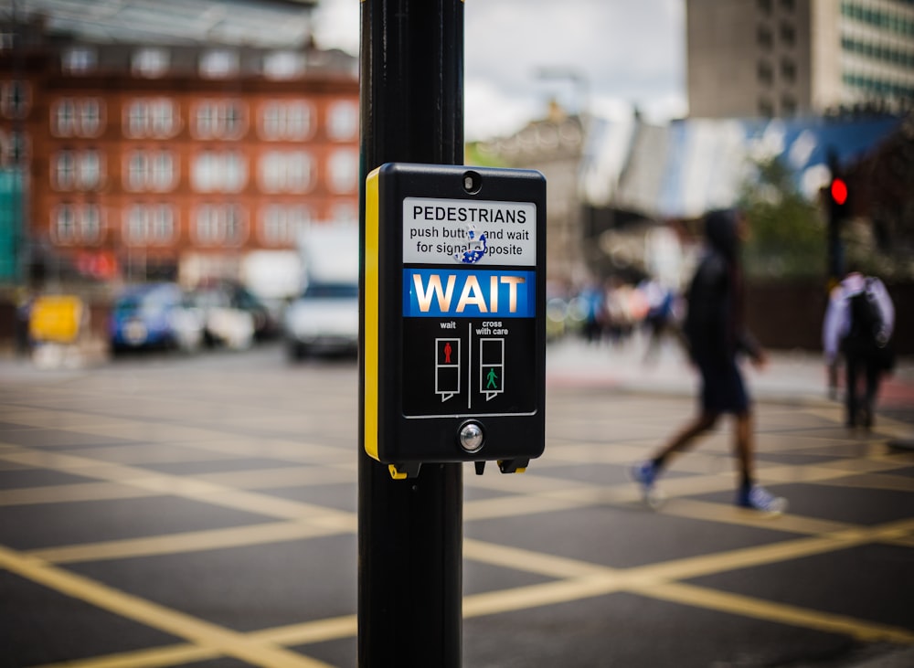 a pedestrian crossing sign on a city street