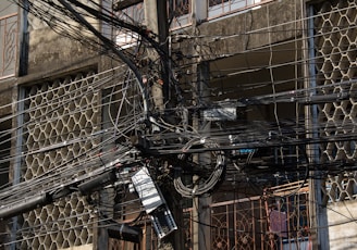 a bunch of wires and wires hanging from a building