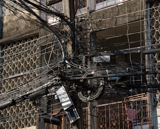 a bunch of wires and wires hanging from a building