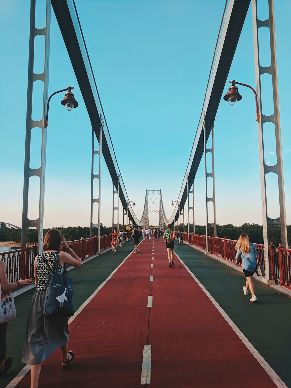 women walking on bridge