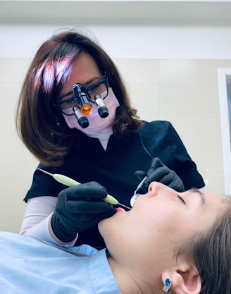 woman holding medical tool on person's mouth