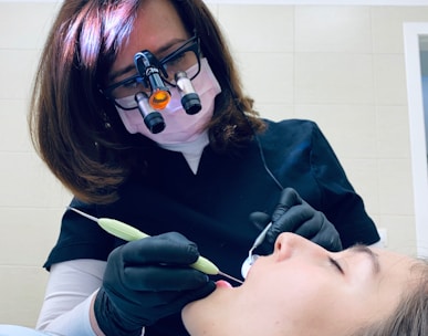 woman holding medical tool on person's mouth