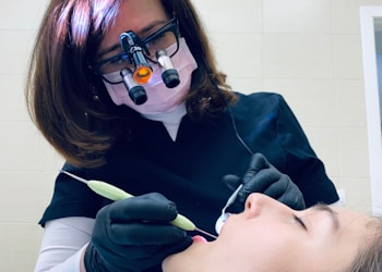 woman holding medical tool on person's mouth