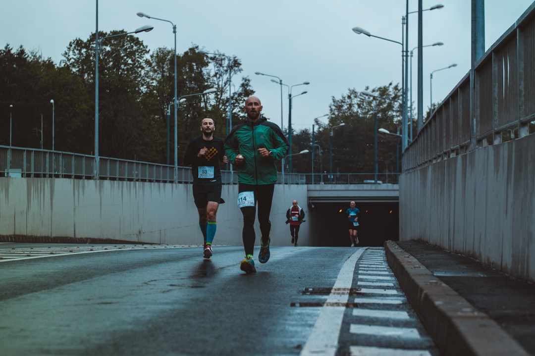 group of people running on street,