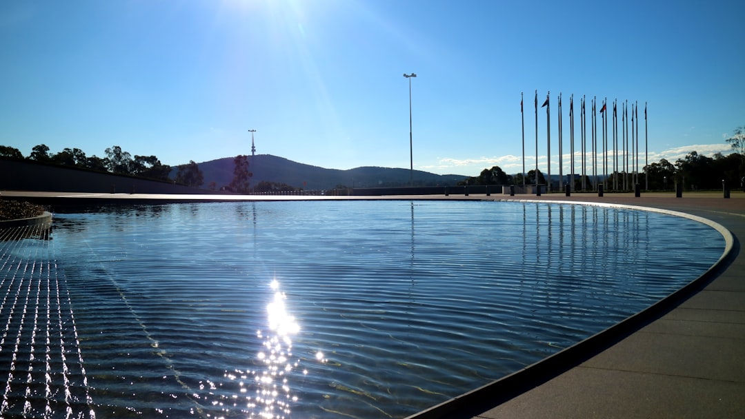 calm water under blue sky,