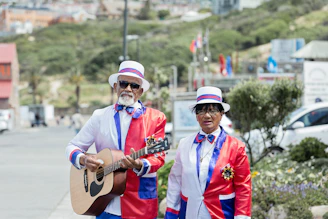 man playing guitar beside man