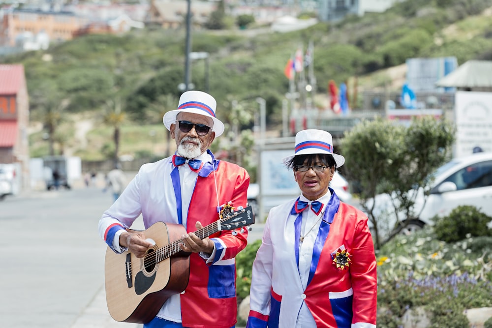 man playing guitar beside man