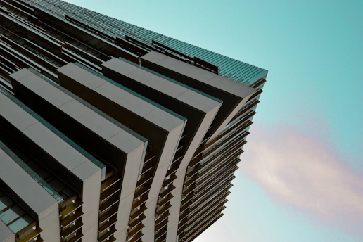 A sleek architectural blueprint overlaid with digital design tools in blue and yellow hues.