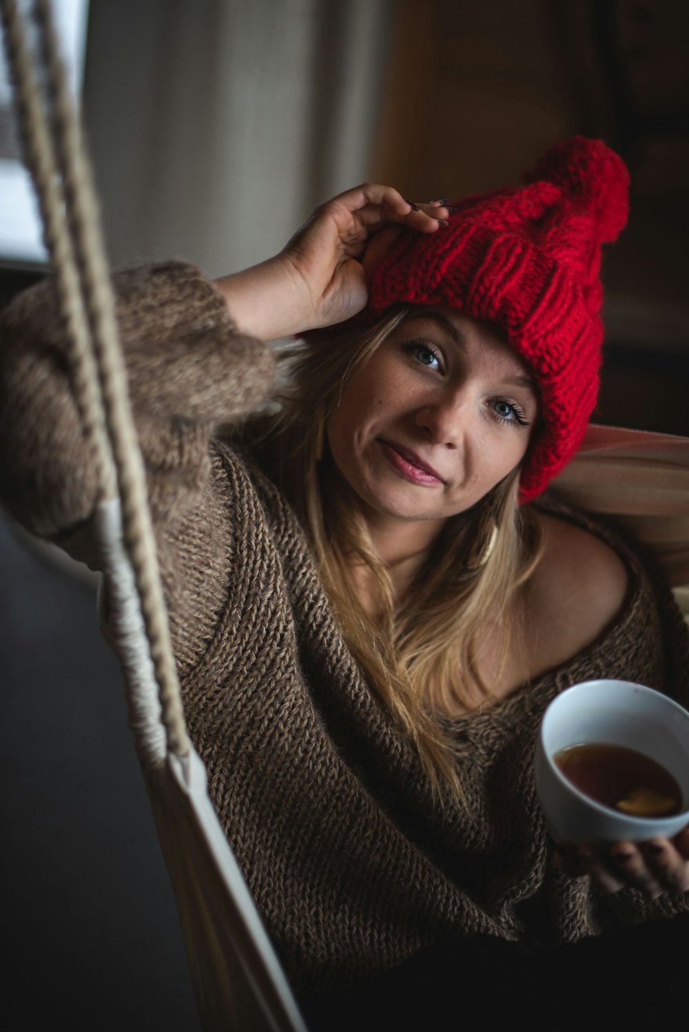 woman holding white ceramic mug