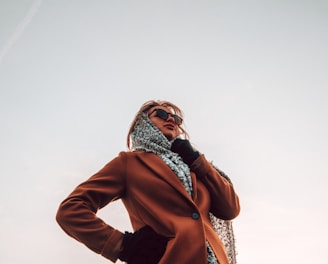 woman wearing brown peaked-lapel topcoat