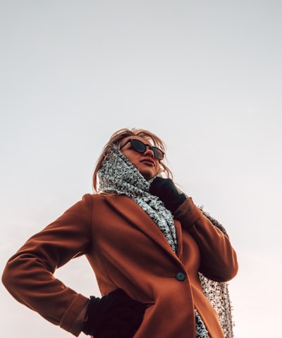 woman wearing brown peaked-lapel topcoat