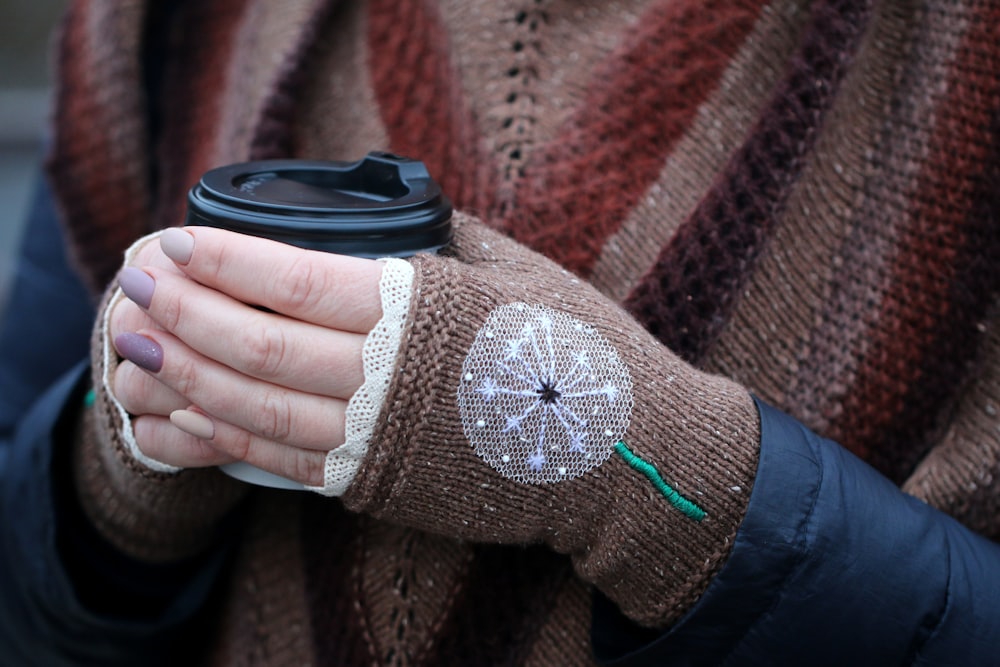 person holding disposable cup