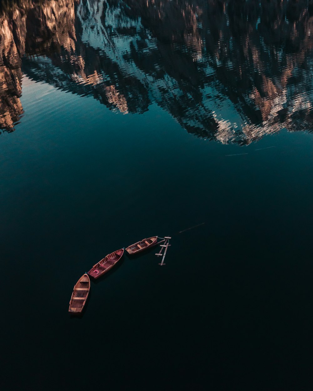 three boat on calm body of water