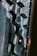 Architectural design with geometric patterns featuring hexagonal shapes made from a combination of glass and dark metal. A warm light bulb is visible among the hexagons, creating a striking contrast against the cool tones.
