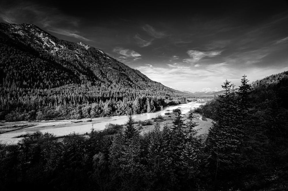 grayscale photography of mountains and river