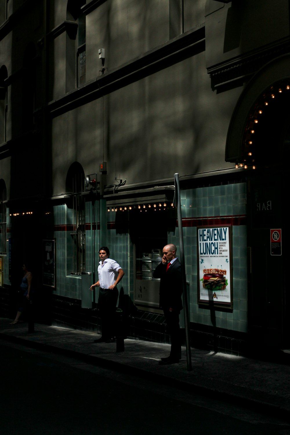 two men standing outside glass walled building