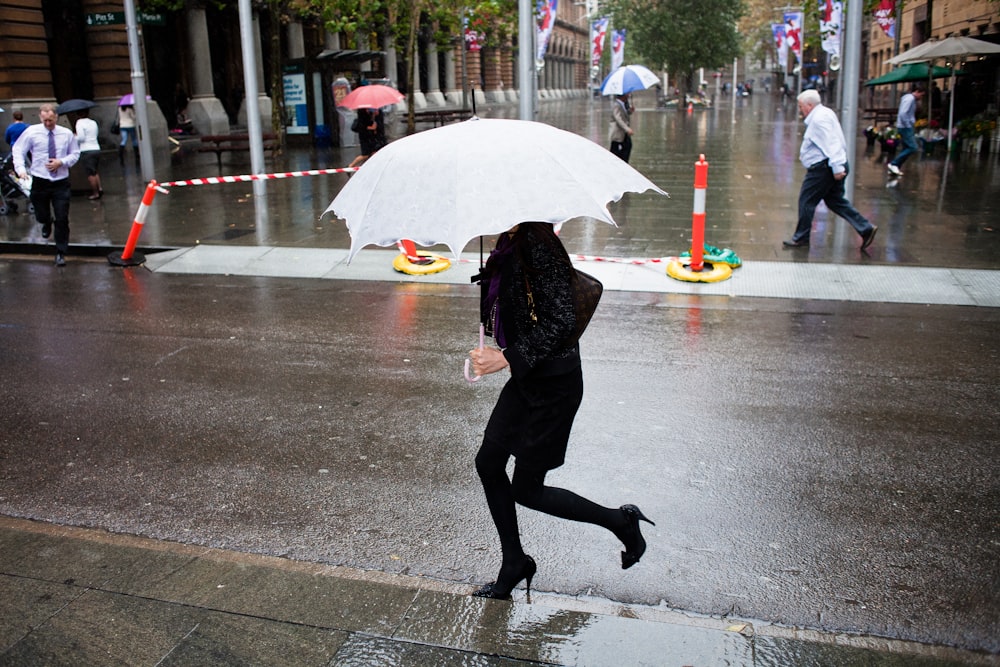 woman carrying white umbrella