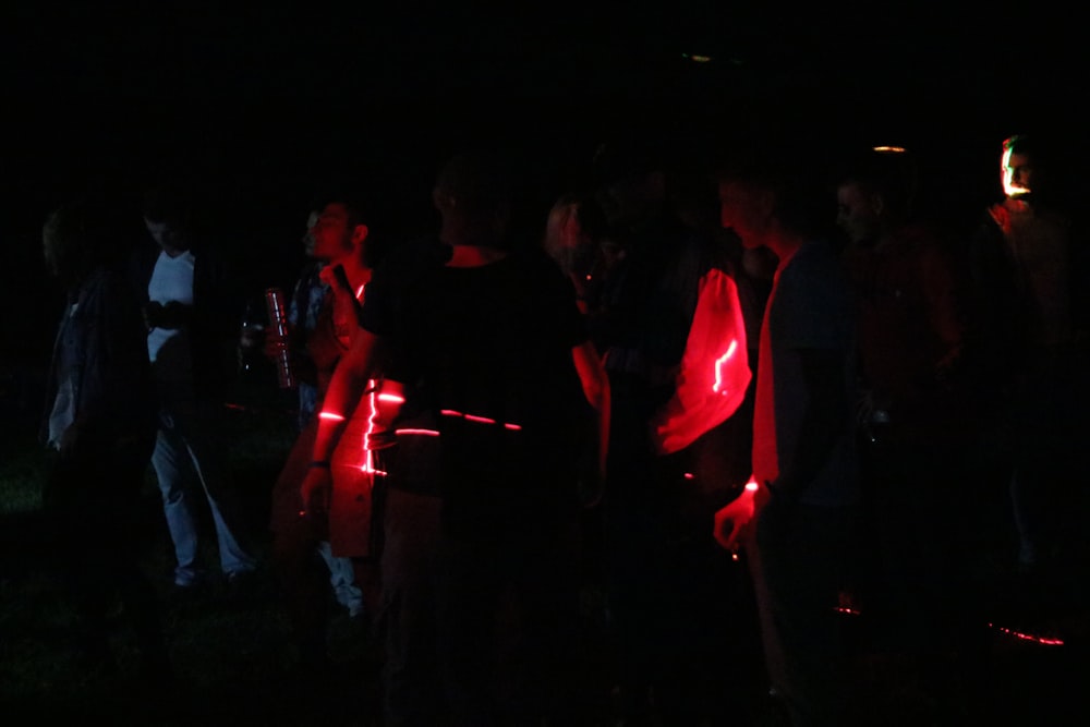 group of people near red neon light