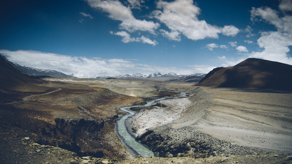 river and dirt field during day