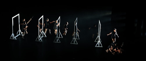 A cinematic frame from a music video featuring colorful lighting and expressive dancers.