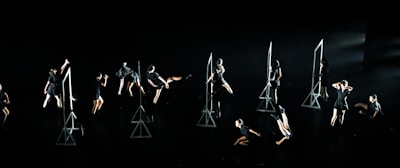A group of young dancers performing a synchronized hip-hop routine outdoors.
